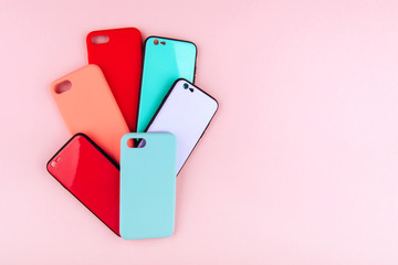 Set of colored silicone covers for smart phone on a colorful background