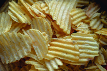 Corrugated potato chips. Mixed set closely. Tasty snack. Macro junk food. Delicious fried potatoes for posters, prints, web, design, market, shop, menu.