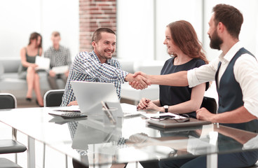 handshake business people sitting at the office Desk.