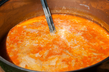 Stainless steel saucepan with tripe soup closeup