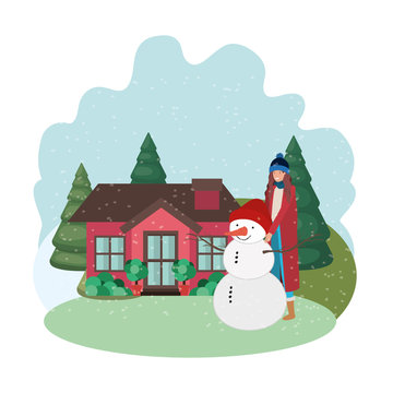 woman with snowman and house in winter