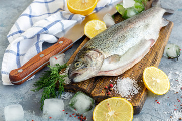 Preparation of trout, sliced lemon and green dill.