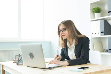 Photography and graphic art concept - Graphic designer using her tablet in a bright office.