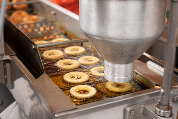 Automatic batter dispenser on a donut frying machine