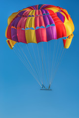 Flying colorful, beautiful parachute in the air.