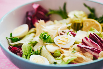 Fresh vegetable salad with quail eggs closeup macro