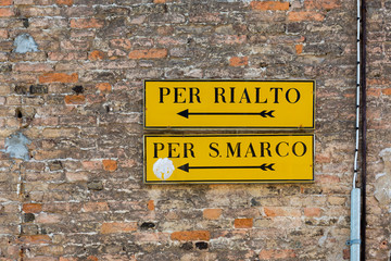 Venice wall mounted direction signs with arrows to Rialto and San Marco