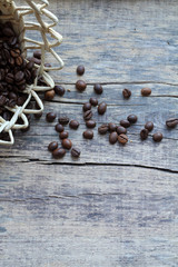 Coffee beans, basket on old wooden background. Сoffee background