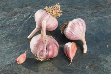Garlic of a new harvest on the stone textured tabletop. Garlic the best drug for influenza. Concept...