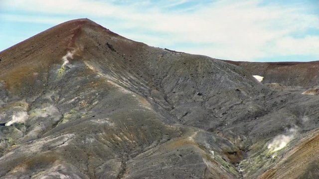 Fumarole field in Ebeko volcano caldera. Emission of hot sulfur gas.