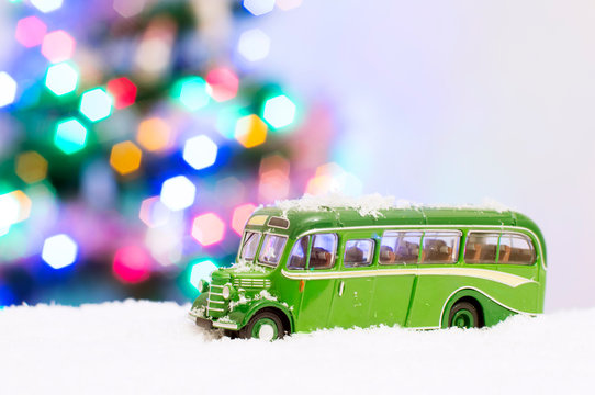 Photo of a green toy bus in the snow