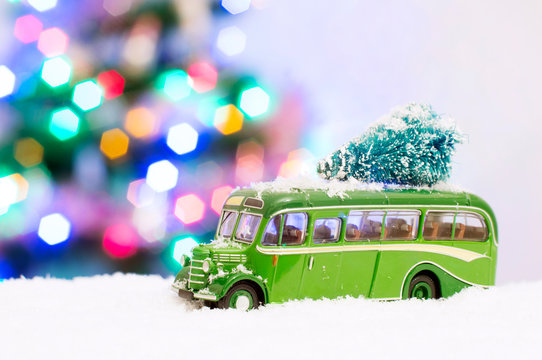 Photo of a green toy bus in the snow