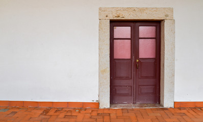 Red weathered wooden doors captured in Lisbon, Portugal