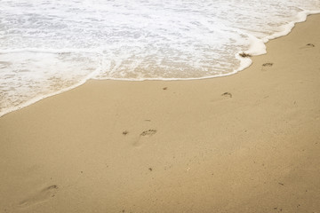 Fototapeta na wymiar Bare feet in the sand.