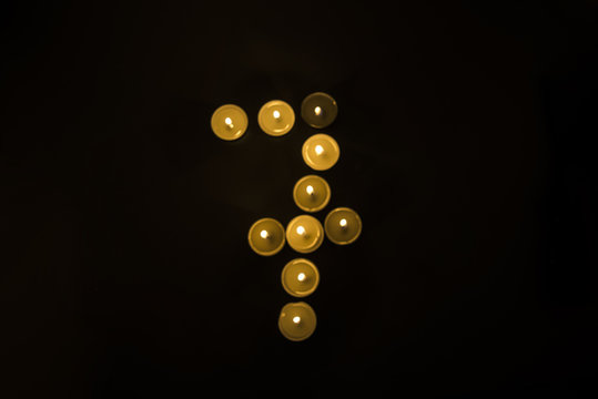 Numbers made from candles on black background.