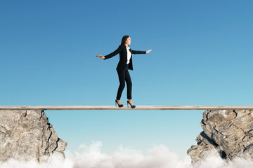 Woman balancing between cliffs