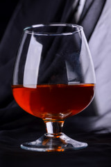 A glass with a red drink and glare on the glass.