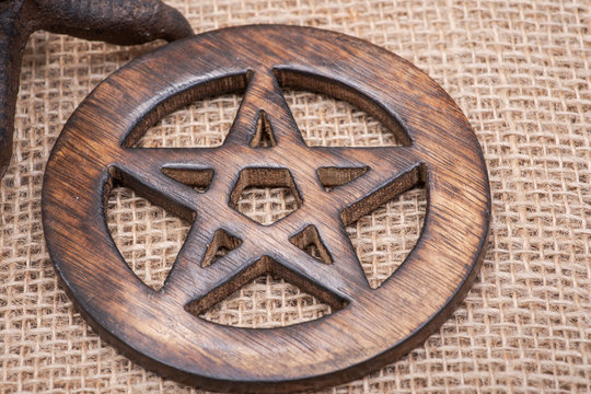 Wooden encircled pentagram symbol on burlap background.. Five elements: Earth, Water, Air, Fire, Spirit.