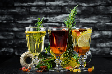 Hot winter wine cocktails. Cinnamon, cloves and honey. On a wooden background.