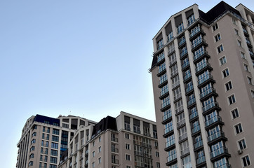 The facade of a high-rise building with windows and balconies. Residential building architecture