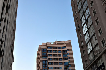 The facade of a high-rise building with windows and balconies. Residential building architecture
