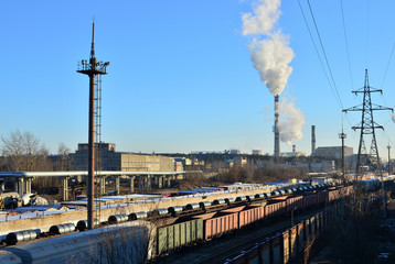 Industrial zone of plants, electrical wires.  Parking freight rail freight trains and wagon.  Railway yard with a lot of railway lines and freight trains.