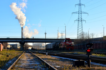 Fototapeta na wymiar Parking freight rail freight trains and wagon. Railway yard with a lot of railway lines and freight trains. Industrial zone of plants, electrical wires.