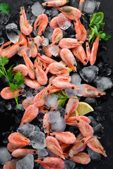 Shrimp with ice and lemon. On the old background. Top view. Free copy space.