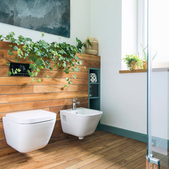 Cozy and mediterranean style bathroom in warm colours and natural wood.