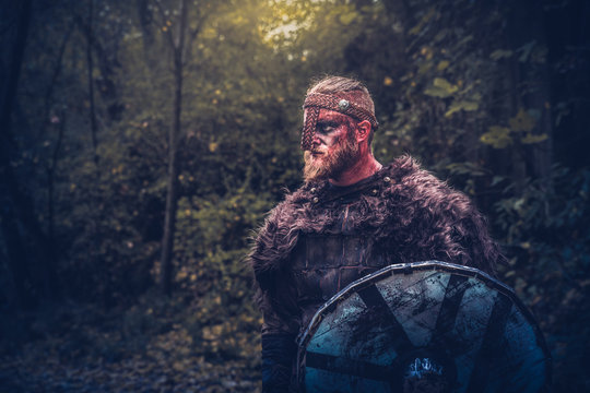 viking with armor and red beard and face with blood