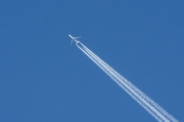 White aircraft three engines aviation airport contrail clouds.