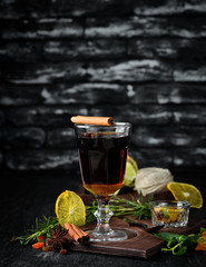 Hot winter wine cocktail. On a wooden background. Top view. Free copy space.