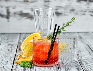 Negroni-Sprits. Alcoholic cocktail in a glass. On a wooden background. Top view. Free copy space.