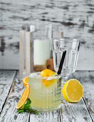 Cocktail Gin tonic with citrus in a glass. On a wooden background. Top view. Free copy space.