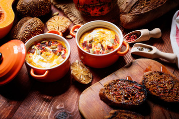 traditional pumpkin cream soup in a rustic style. healthy eating concept.