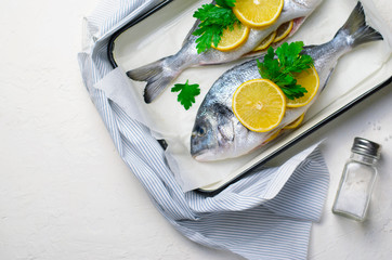 Fresh Dorado or Sea Bream with Lemon and Herbs, Raw Fish Ready to be Cooked, Top View