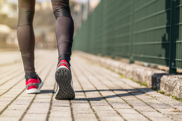 Sport.Runner feet running on road closeup on shoe