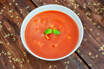 Tomato soup on wooden table