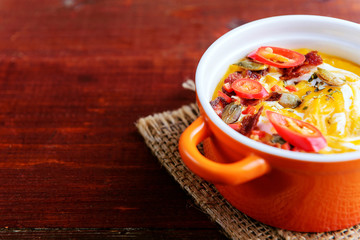 traditional pumpkin cream soup in a rustic style. healthy eating concept.