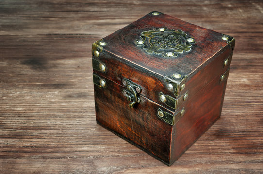 Old treasure box on wooden background