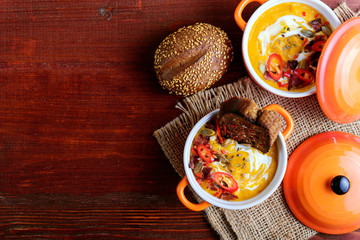 traditional pumpkin cream soup in a rustic style. healthy eating concept.