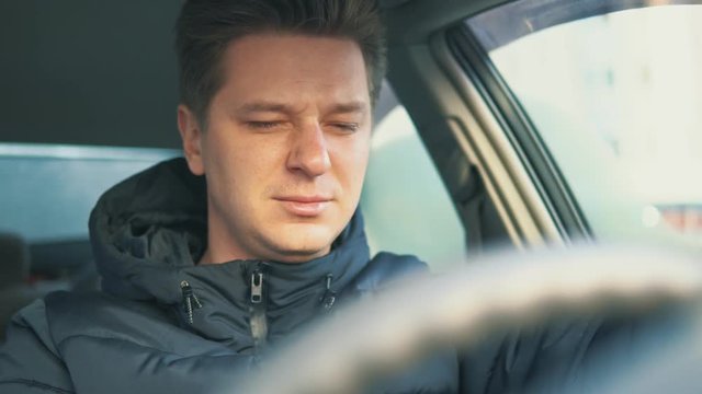 young man crying in the car. depression