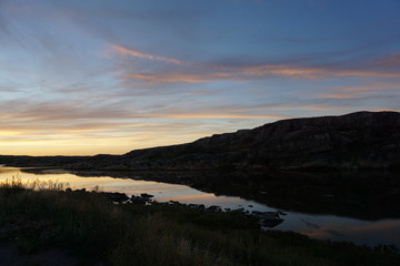 unset on Smögen in summer in Sweden with black hill and blue orange sky