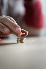 Closeup of male senior hand counting Euro coins