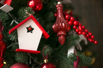 New Year's red toys on a Christmas tree.Beautiful shiny stars on a branch .Christmas background for postcard.
