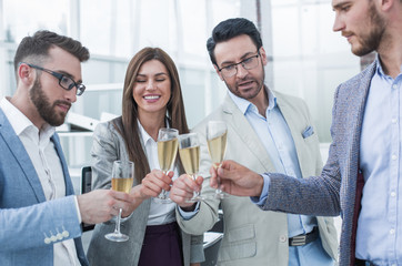 close up.business people celebrate with champagne