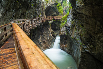 Hiking along a woodend boardwalk in a canyon near Kaprun, Austria, Europe