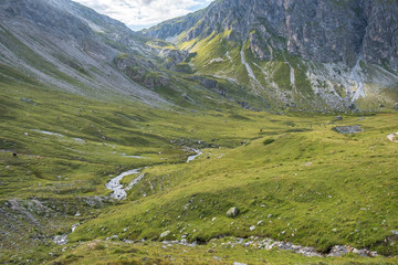 Fototapeta na wymiar Beautiful Swiss mountain landscape green grass, blue sky, white clouds, summer day, paved paths