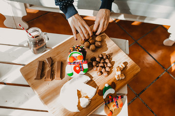 .Sweet and cheerful woman enjoying christmas at her home. Wearing christmas costume and eating tipical sweets. Lifestyle. Season photography.