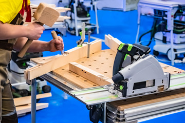 A carpenter. Chisel. Joiner working in the shop. Carpenter works as a chisel. Cutting machine. Carpenter work. Carpentry workshop. Carpenter at work.